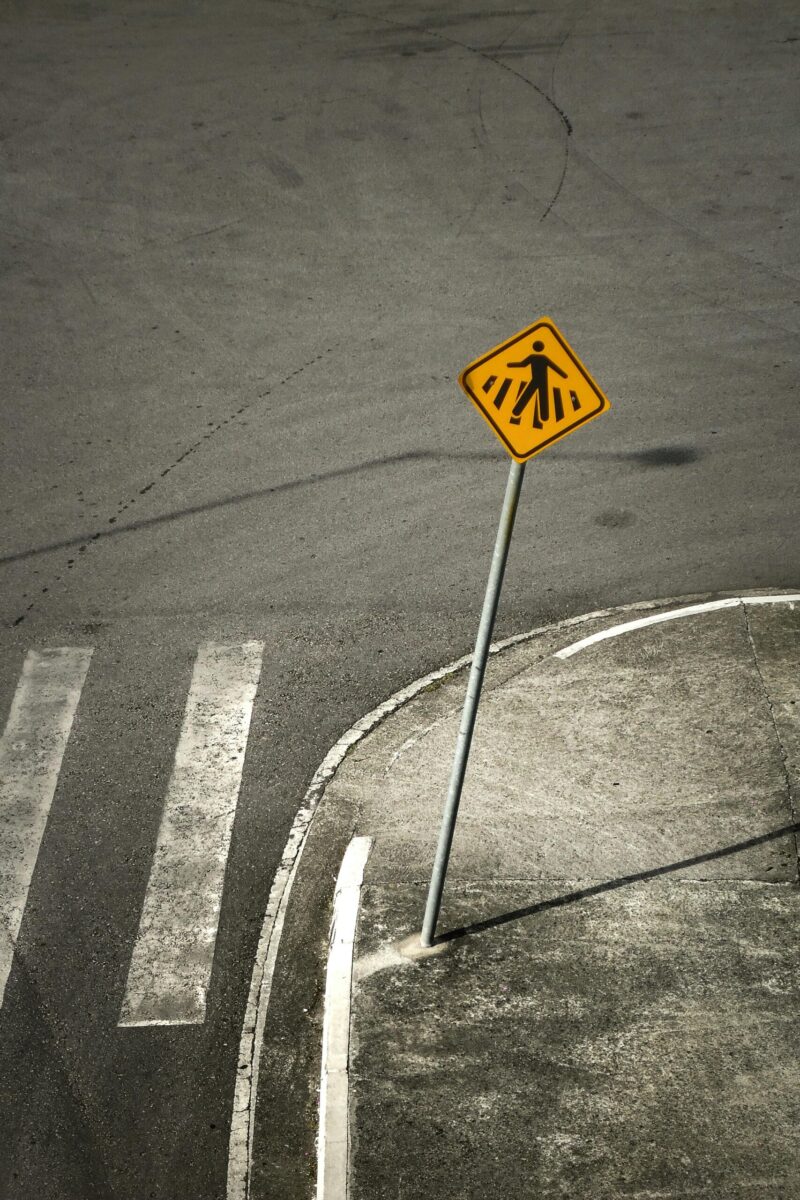 Pedestrian crossing sign on an empty urban street in SC, Brazil.